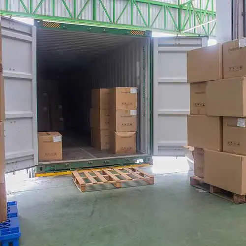 Loading shipping containers with hydraulic repair kits at China manufacturing hub.